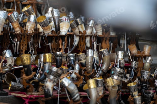 Preview: Collection of Ornate Drinking Horns on Display at a Local Artisan Market in Autumn