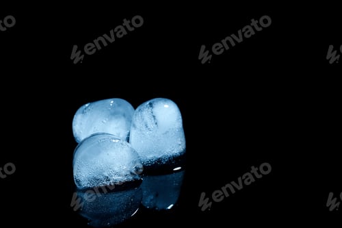Preview: Melting ice cubes on black background. Space for text
