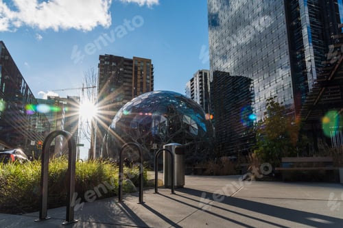 Preview: Modern bicycle racks with Amazon Spheres and sunburst lens flare in downtown Seattle lay day sun