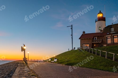 Preview: Urk Flevoland Netherlands sunset at the lighthouse and harbor of Urk Holland. Fishing village Urk