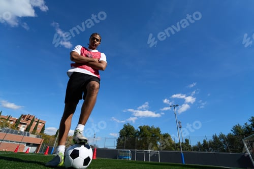 Preview: Confident young man athlete standing on soccer field