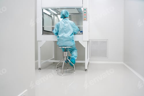 Preview: Worker in Clean Suit at Laboratory Workbench