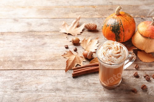 Preview: Glass cup with tasty pumpkin spice latte and space for text on wooden table
