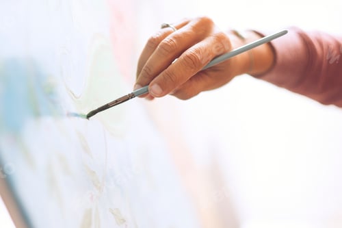 Preview: Closeup of woman hand painting an art wallpaper with old style - creativity and artist at work