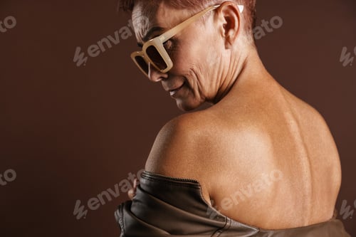 Preview: Senior shirtless woman in sunglasses posing and looking aside