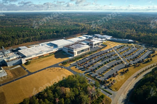 Preview: Aerial view of many employee cars parked on parking lot in front of industrial factory building