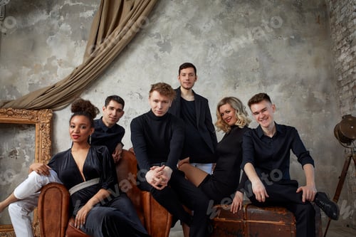 Preview: Portrait of overjoyed happy millennial gen z diverse multiethnic friends relax on sofa have fun