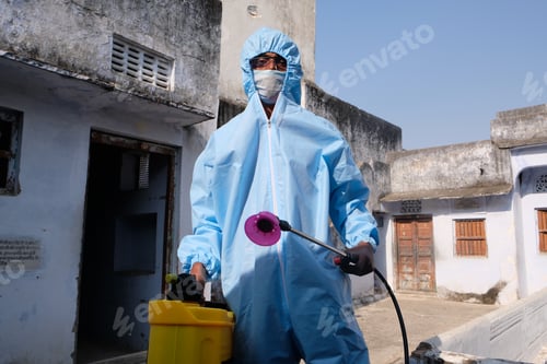 Preview: Indian sanitary worker in a protective suit conducting disinfection of a school during COVID-19