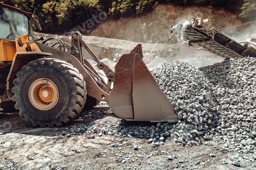 Preview: Wheel loader machine unloading rocks in the open pit mine and ore quarry