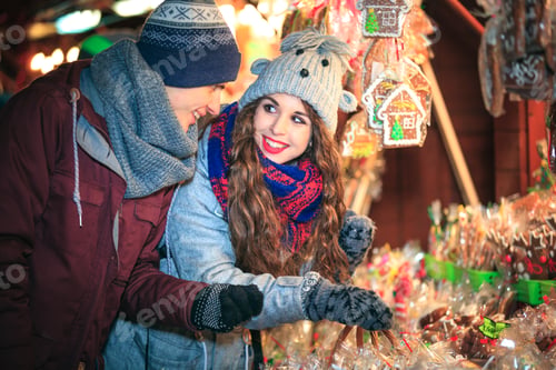 Preview: Christmas market shopping, couple choosing things for buying