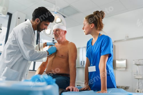 Preview: Young doctor and nurse treating injury of senior man.