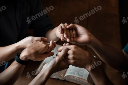 Preview: A group of young Christians holding hands in prayer for faith and scriptures