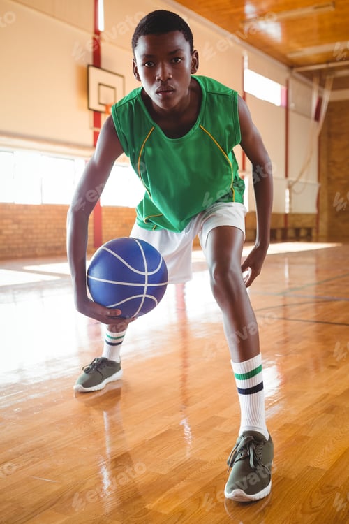 Preview: Portrait of teenage boy playing basketball