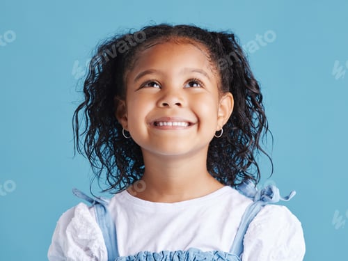 Preview: Close up head shot with smiling little brown haired girl looking up. Happy kid with good healthy te