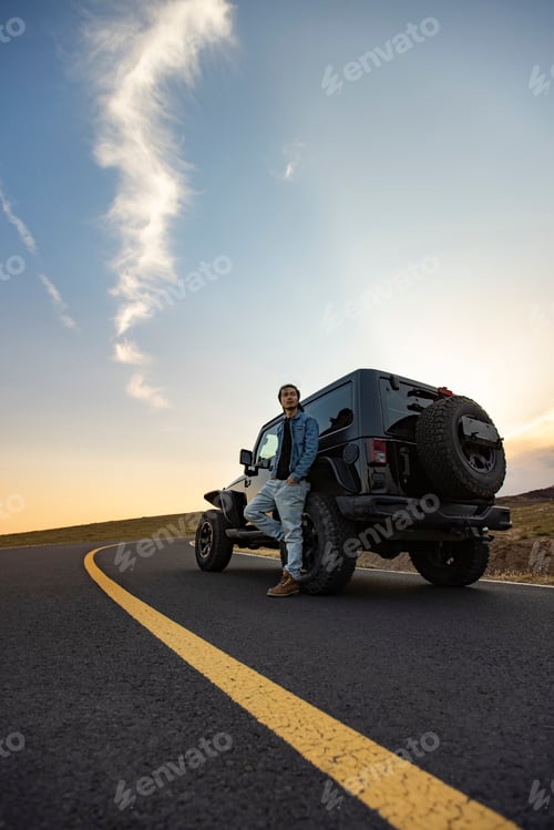 Preview: Happy Chinese mid adult man enjoying road trip