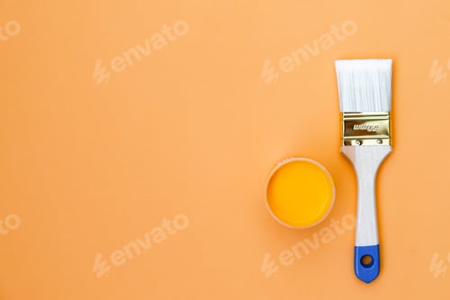 Preview: Paint can and brush on orange background. House renovation concept.