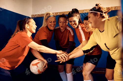 Preview: United women's soccer team stacking hands before the match.