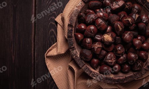 Preview: roasted chestnuts, in a wooden plate, top view, homemade, no people,