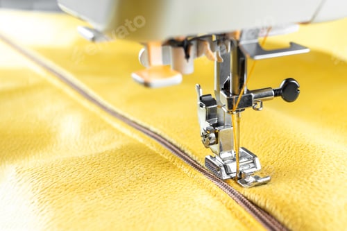 Preview: Modern sewing machine and yellow fabric. Sewing process, handmade, hobby, DIY, business, repair