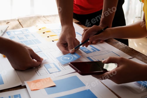 Preview: Group of ux developer and ui designer brainstorming about app interface design at modern office