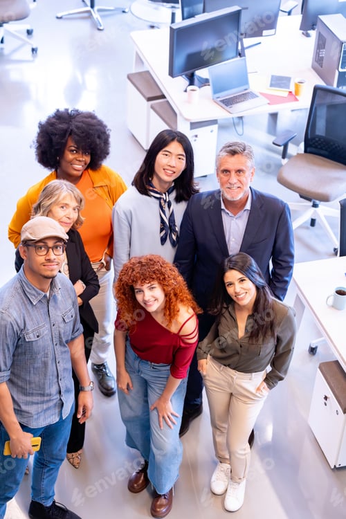 Preview: Diverse business team smiling while posing together in the office.