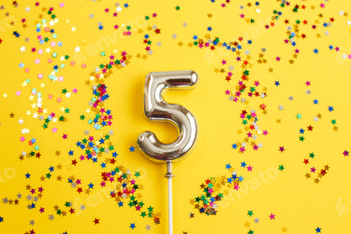 Preview: five years birthday party. number five with multicolored confetti in the form of stars