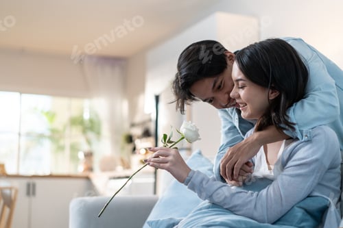 Preview: Asian young man surprise and give rose flower to beautiful girlfriend.