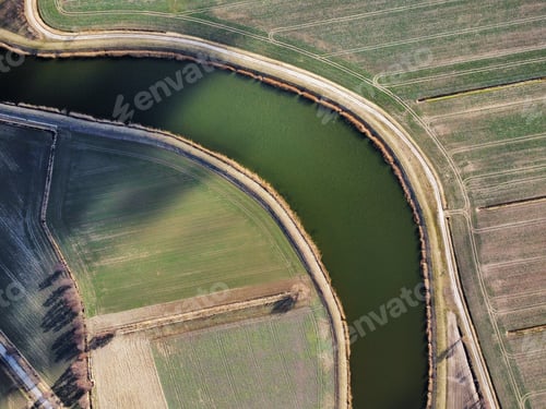 Preview: Drone shot of a river in a field