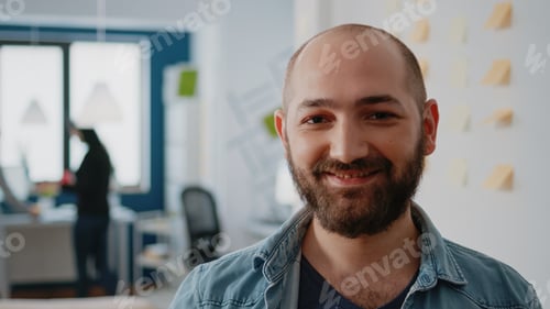 Preview: Portrait of businessman holding bottle of beer after work in office