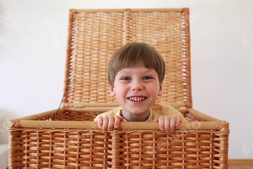 Preview: Cute kid play and hide in basket.