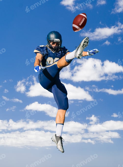 Preview: American football player jumping and kicking ball