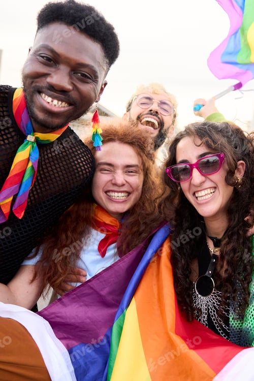 Preview: Happy group posing with rainbow flag for a fun event