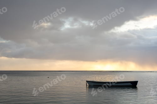 Preview: Beautiful sunset in the ocean with a fishing boat