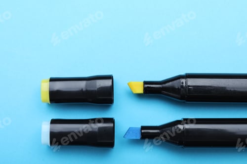 Preview: Two color markers on light blue background, top view