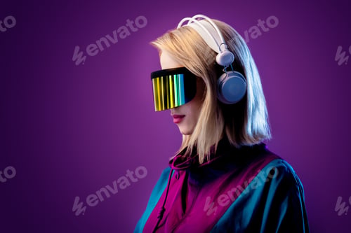 Preview: Blonde in VR glasses and headphones on pink background