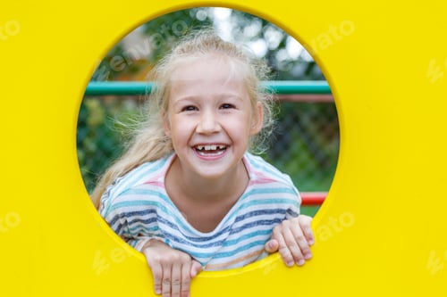 Preview: Beautiful cheerful little girl on the Playground.