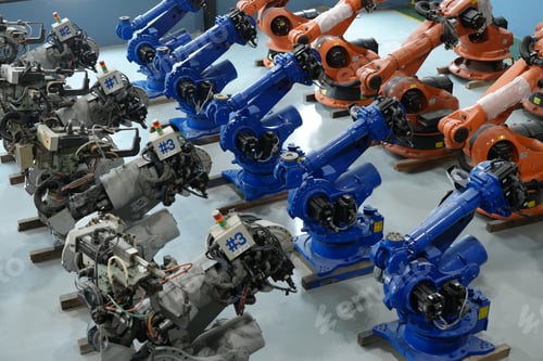 Preview: Robotics engineer working on maintenance of robotic arm in factory warehouse. Business technology.