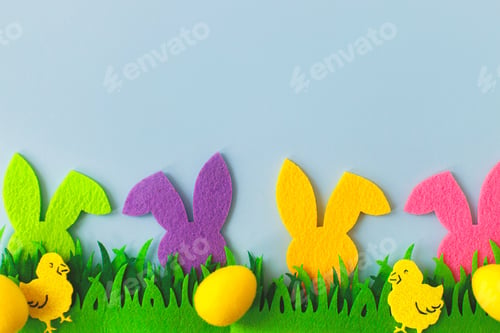 Preview: Easter hunt. Colorful Easter bunnies, eggs, chickens in grass on blue background, top view