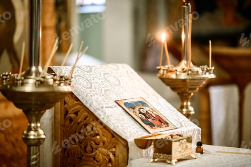 Preview: the icon lies on the altar in the church. candles are burning around her