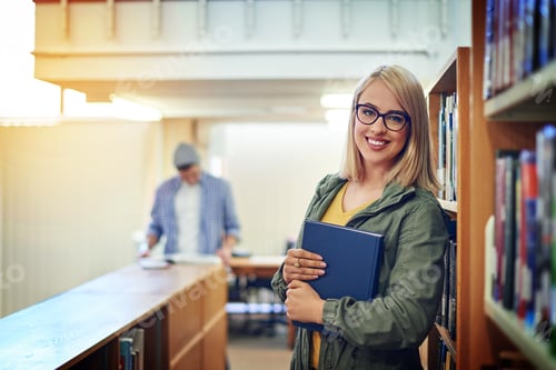 Preview: Portrait of a university student standing in the library at campus