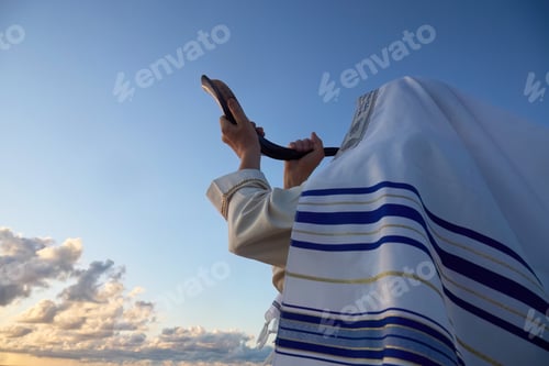Preview: Jewish man blowing the Shofar horn of Rosh Hashanah - New Year. Blowing the Shofar at Dawn
