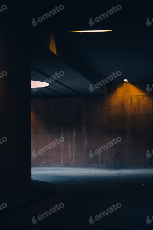 Preview: Vertical shot of a dark tunnel with a little light sources