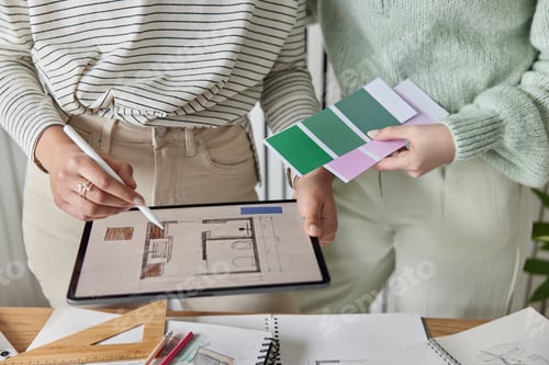 Preview: Cropped shot of unrecognizable women work on interior design hold color samples draws scheme on
