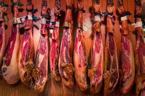 Preview: Spanish cured ham hanging in Boqueria Market, Barcelona, Catalonia, Spain, Europe
