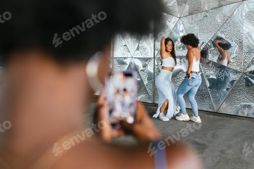 Preview: Friends dancing while recording in video with the mobile