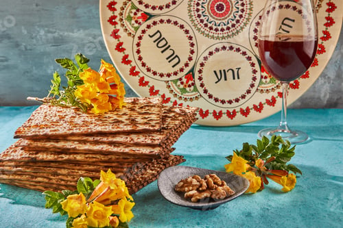 Preview: Pesach celebration concept-Jewish holiday Pesach. Background with yellow flowers with glass of wine