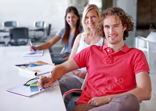 Preview: Three creative professionals sitting in a line in their boardroom together