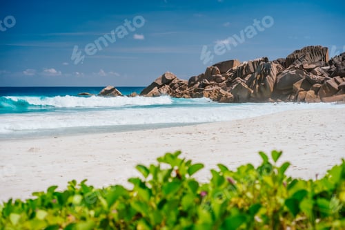 Preview: La Digue Island, Seychelles. Sunny vacation on Grand Anse beach with beautiful ocean waves and