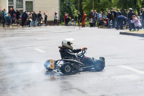 Preview: Karting - driver in helmet on kart circuit