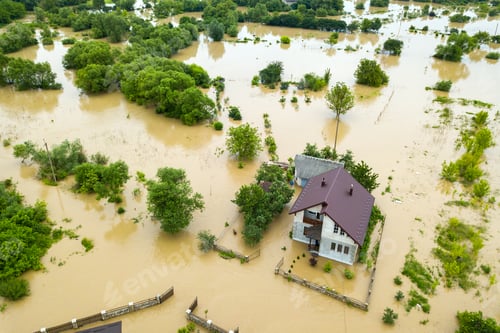 Preview: Aerial view of flooded house with dirty water all around it.
